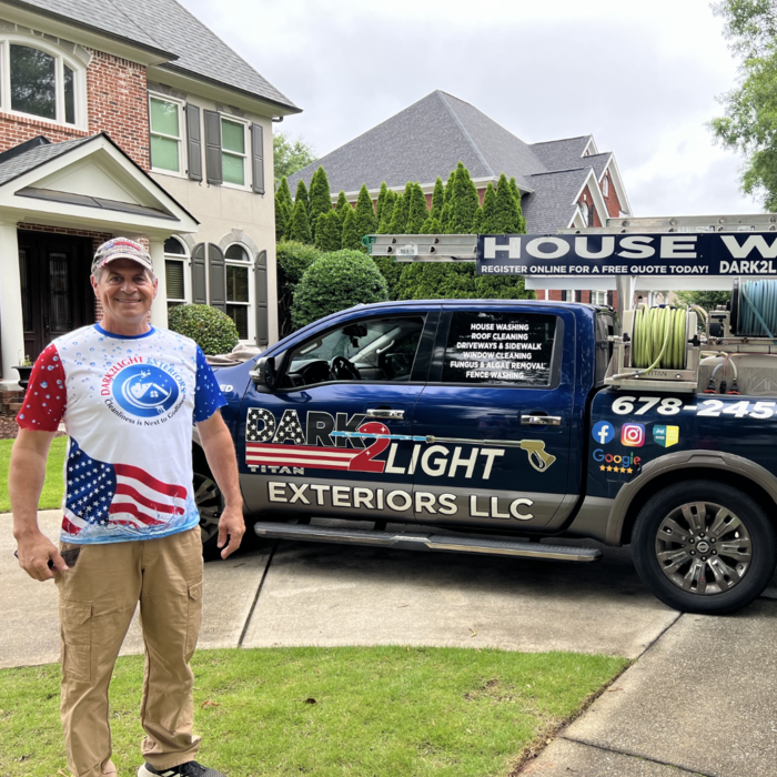 Dark2Light Exteriors team member with branded truck